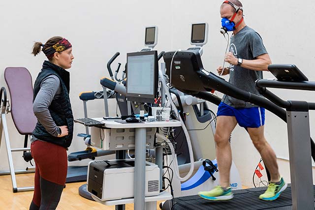 Woman helping someone on a treadmill