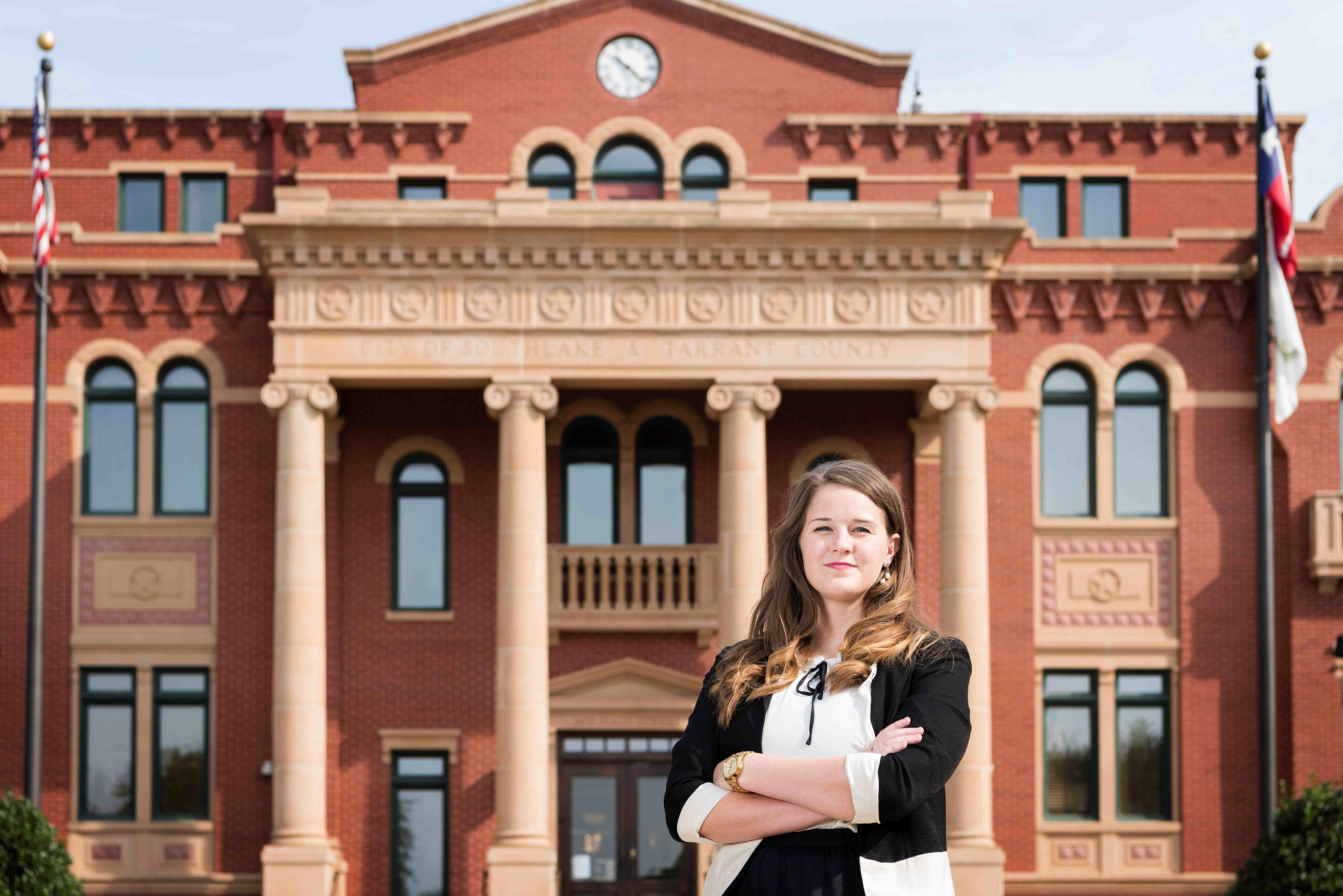 City employee standing in front of a city hall building