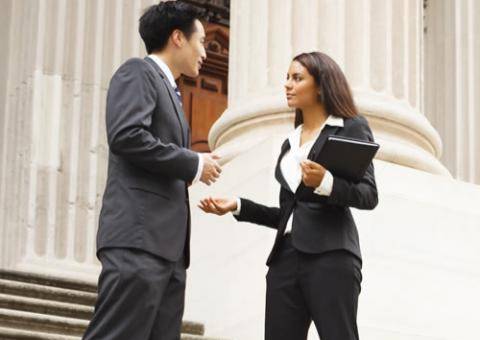 Woman and man having passionate discussion in front of courthouse