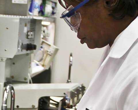 Researcher in lab coat working in a lab
