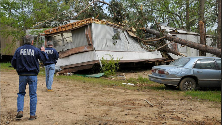 Two FEMA representatives at the site of tornado wreckage