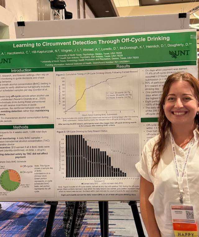 Researcher standing next to research poster