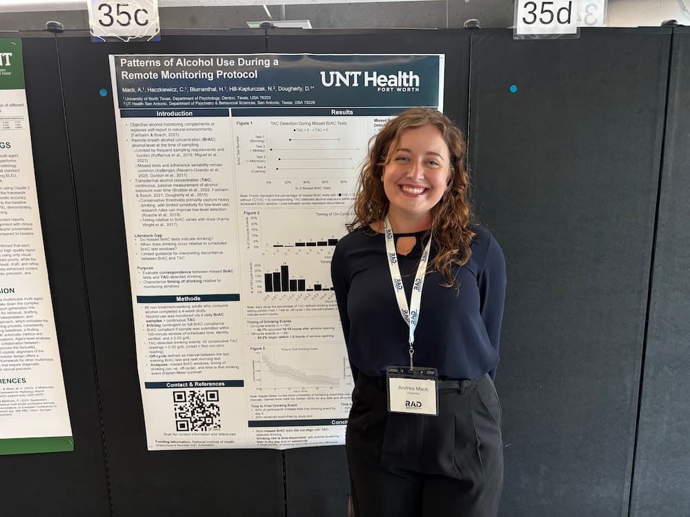 Researcher standing next to research poster
