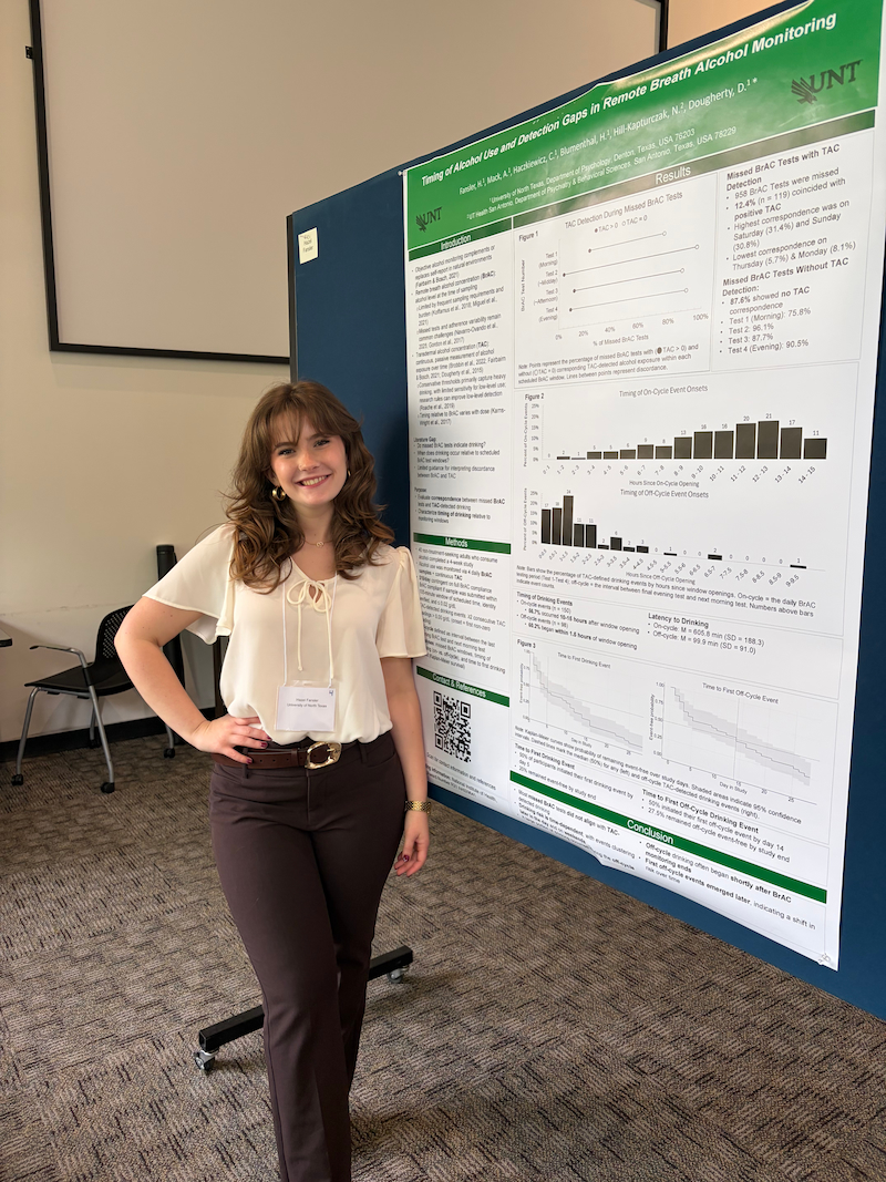 Researcher standing next to research poster