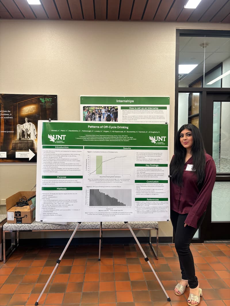 Researcher standing next to research poster